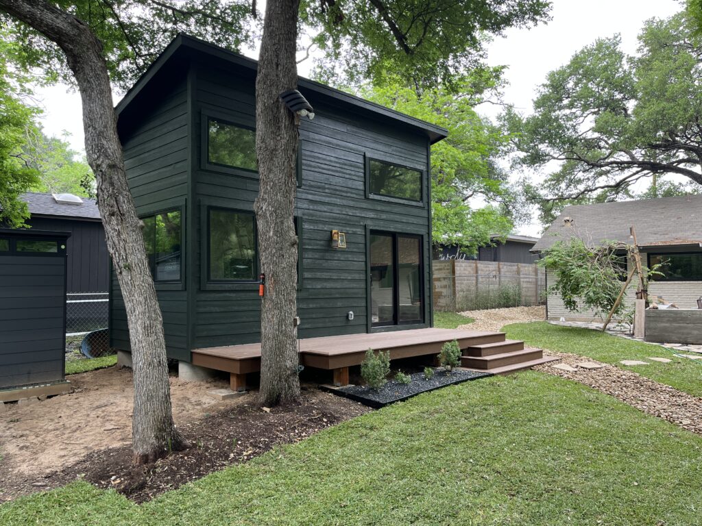 Shed-style casita in forest green color built as a guest space in Austin. 